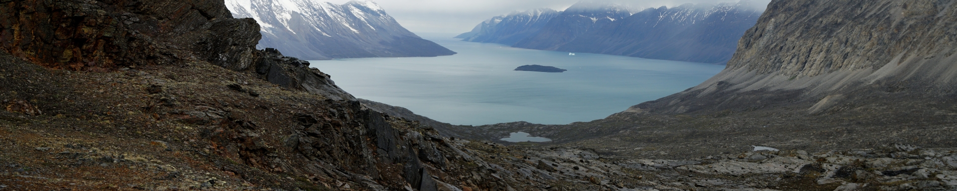 glacial valley looking out to marine bay with snow capped mountains